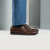 Styled Fit Perspective of Director Wholecut Brown Leather Shoes For Men on Model - Natural Daylight Drape